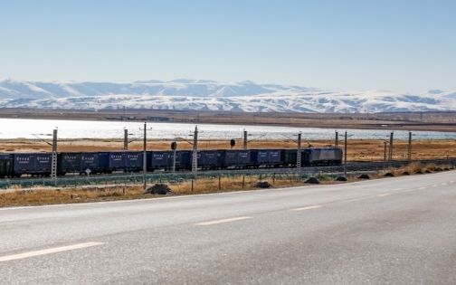 The Qinghai-Tibet Railway train passes by the shore of Qinghai Lake.