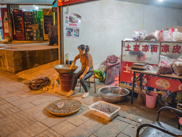 zhangjiajie/China - 15 October 2018:Unacquainted chinese people Cooking Roasted sunflower seeds on the street in zhangjiajie city China