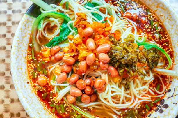Spicy noodle soup with vegetables, herbs, peanuts and coriander, popular in Yunnan Province, shallow depth of field, China.