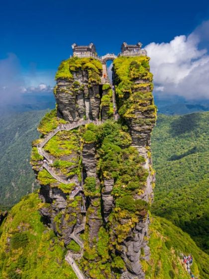 Close up aerial view of Fanjingshan mountain with view of new golden summit with Buddhist temple on the top in Guizhou China.